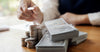 Man stacking coins and bills