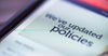 closeup-smartphone-message-we've-updated-our-policies