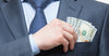 businessman-putting-cash-in-pocket