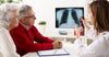 doctor-talking-to-two-elderly-patients